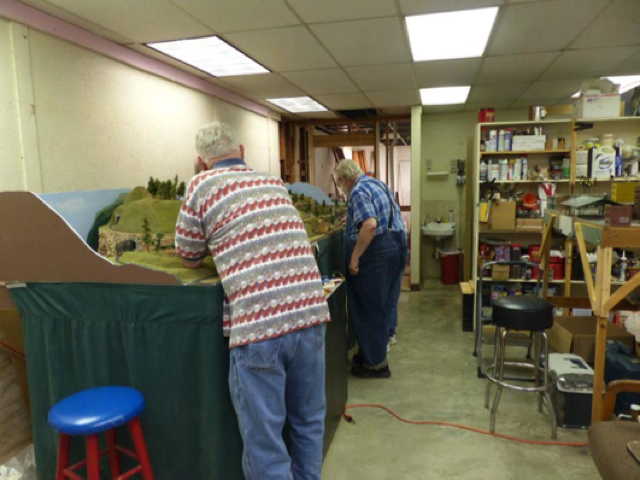 Here we see some of the guys working on the railroad from front to 
		rear George W, Bob T, and Ron M, Ron is in the pair of shoes just visible past 
		Bob.
